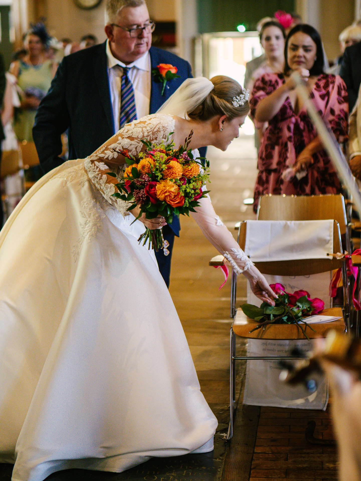 Lily holding her bouquet inside All Saints Church