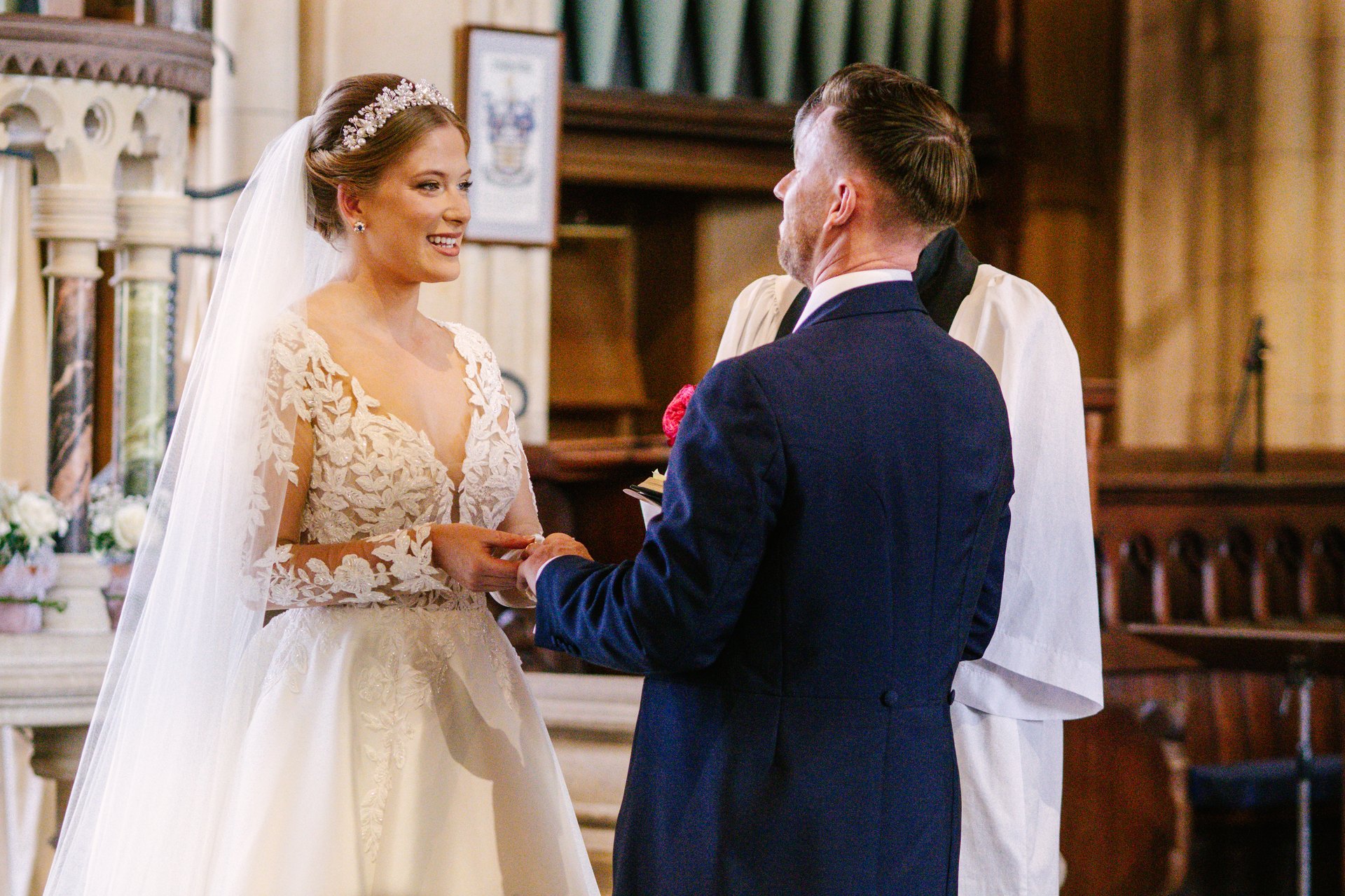 Lily and Piers exchanging vows at All Saints Church