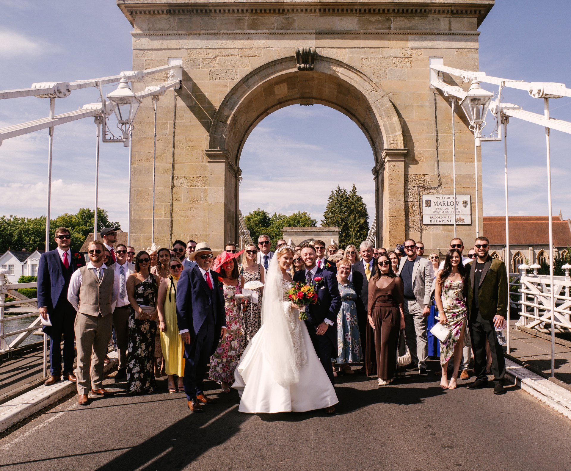 Lily and Piers with their wedding party on Marlow Bridge