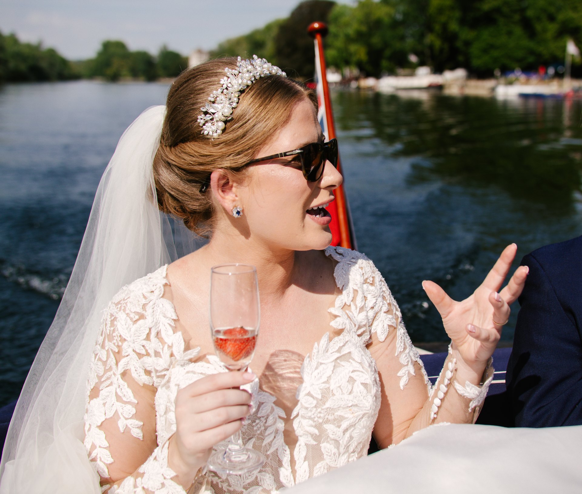 Lily wearing sunglasses and holding a drink during the boat trip